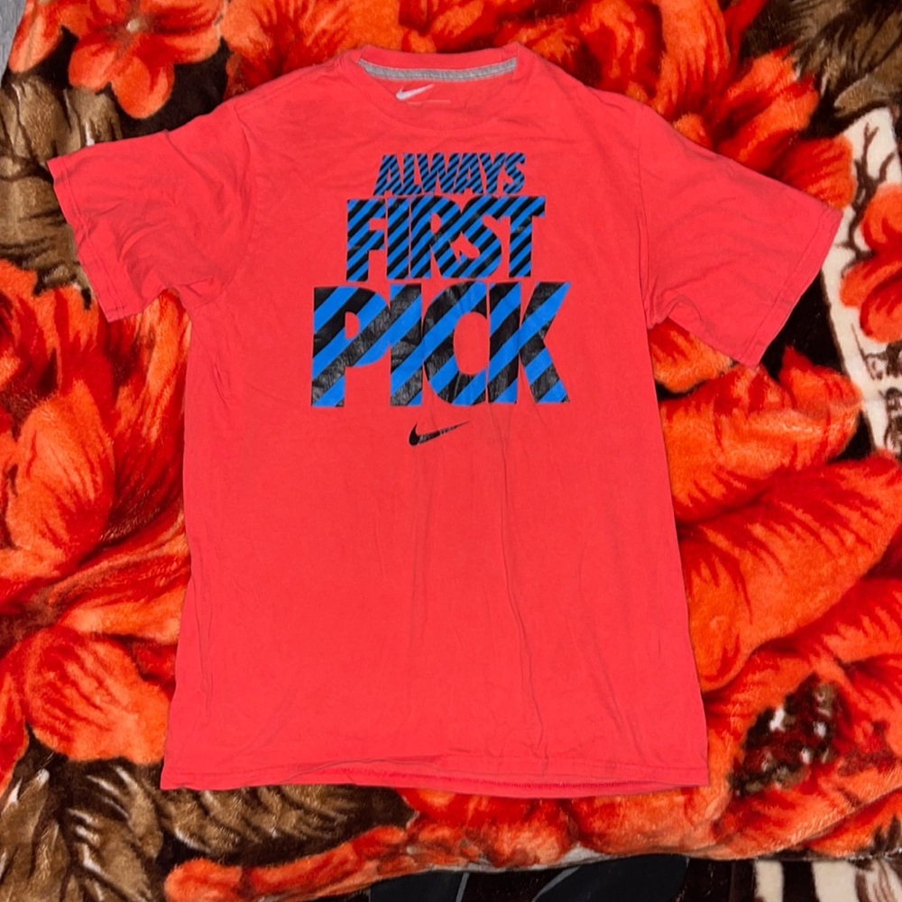 Red Nike tee “always first pick”